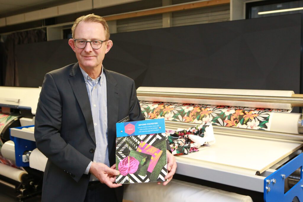 Ron Sportel van Coldenhoven, toont een sampleboek met her resultaat op verschillende soorten textiel.